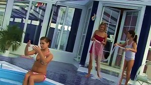 Three Muff Divers Play With A Huge Dildo Beside A Pool
