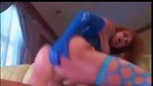 Red-haired  In Blue Latex And Fishnets Gets Fucked In The